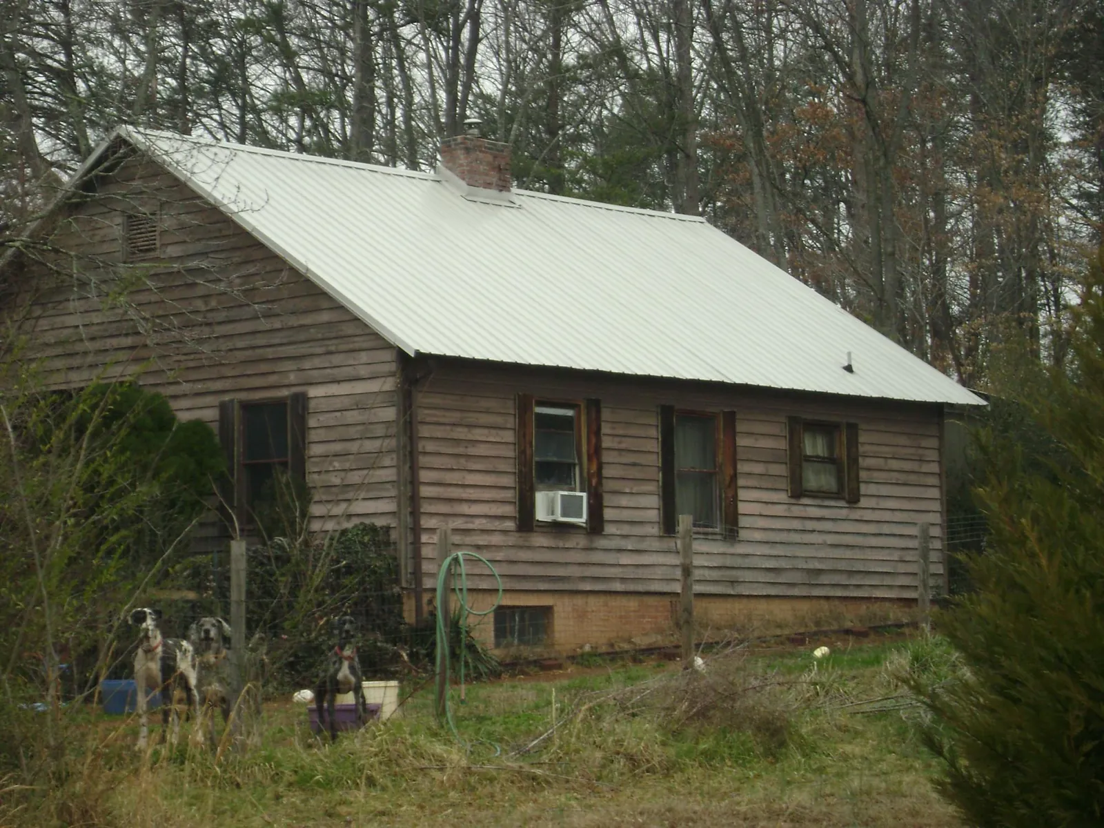 White metal roof on an old wood sided farmhouse, from a Metal Roof Installation job in West Chesterfield